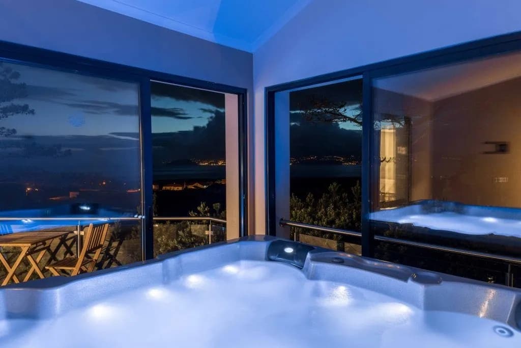 Indoor jacuzzi spa area with ambient lighting